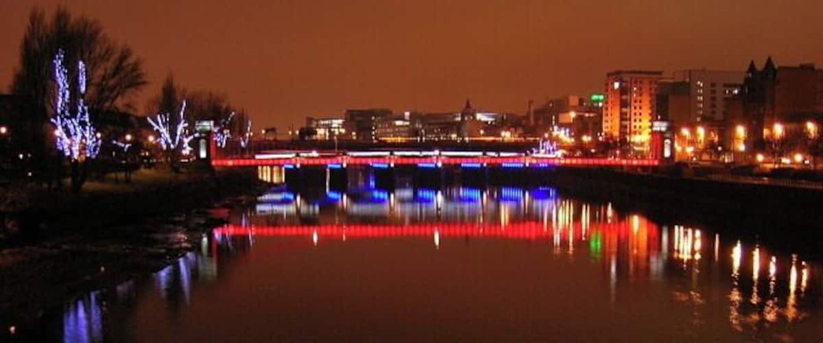 River Clyde at Nighttime The red bridge is the suspension footbridge while the blue bridge is Glasgow Bridge (road bridge)