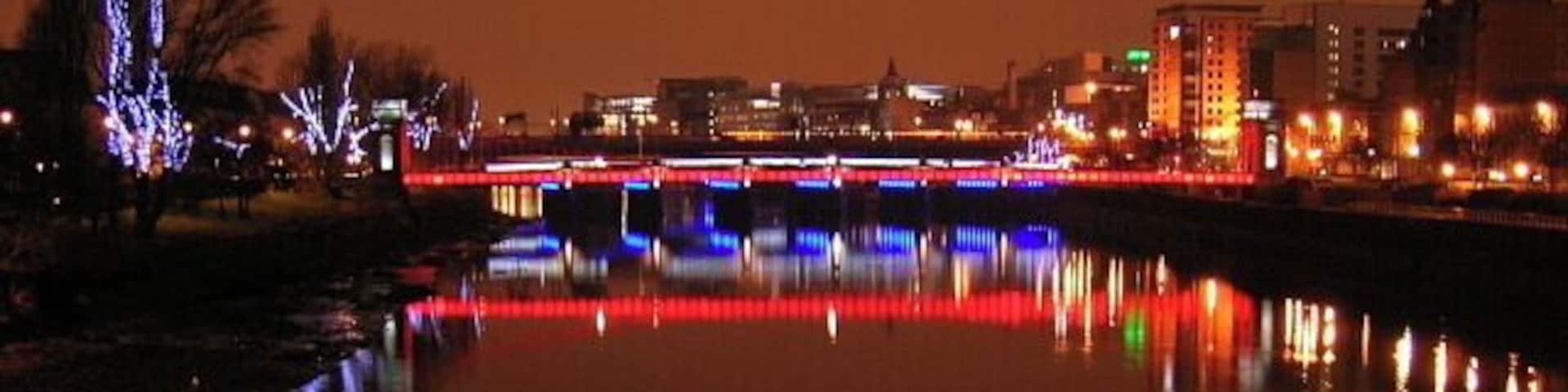 River Clyde at Nighttime The red bridge is the suspension footbridge while the blue bridge is Glasgow Bridge (road bridge)