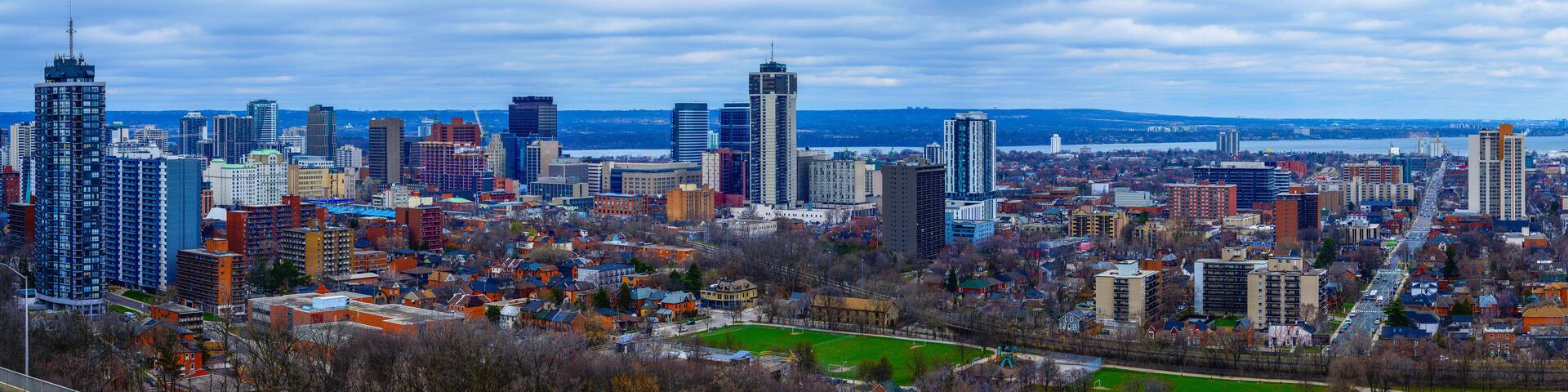 Hamilton Ontario city skyline, downtown buildings, horizon, and the Lake Ontario in the distance in Canada, view from the Niagara Escarpment in Sam Lawrence Park