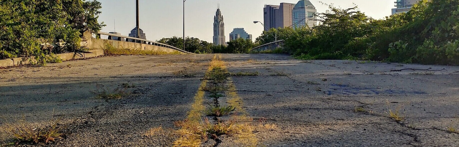 Looking at the Leveque Tower and downtown Columbus from an abandoned highway overpass near Scioto Audubon Metro Park.