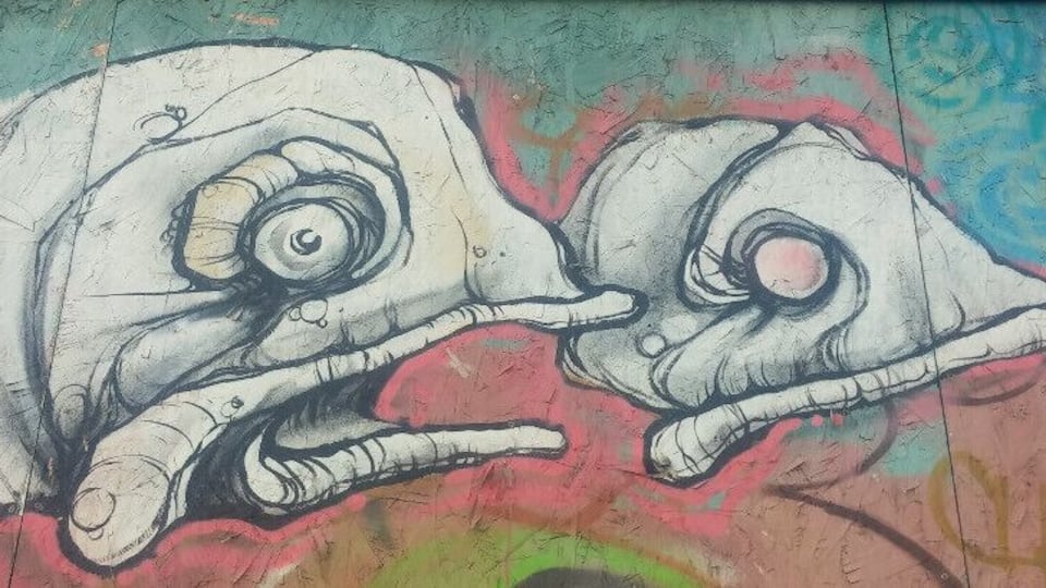 A graffiti mural of two elephants with exaggerated features.