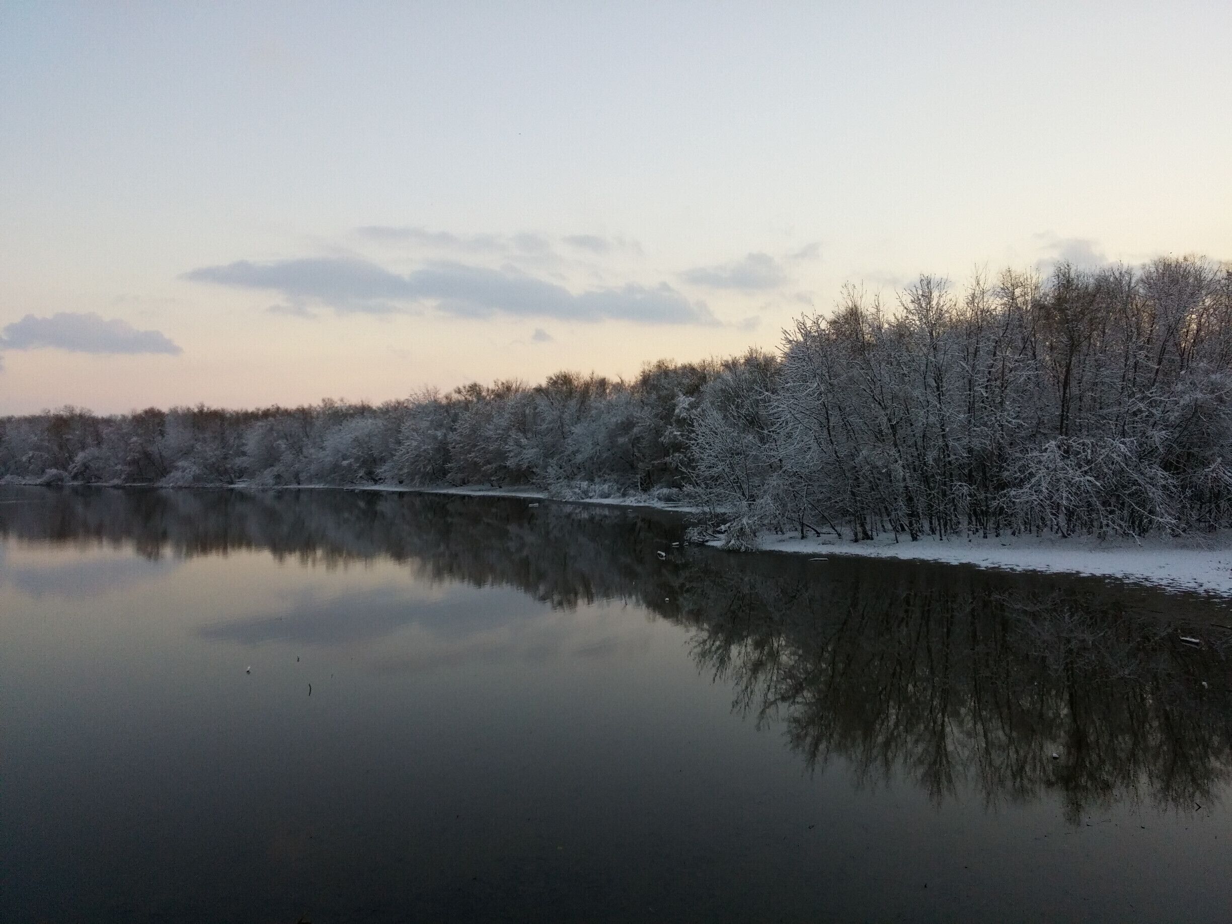 A sunset scene of the snow covered trees along this inlet of the Scioto River. In the warmer months, looking down from this observation platform rewards park visitors with a view teeming with an array of native turtle species sunning themselves on the natural flotsam and jetsam of fallen tree branches.