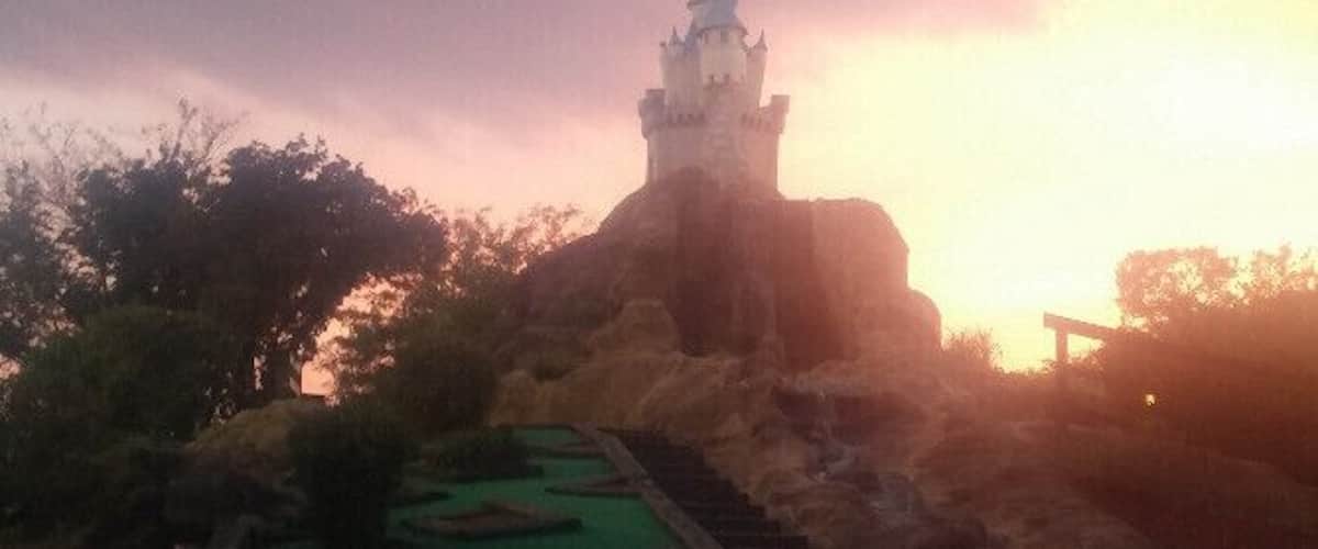 All luck, no skill on this downhill slope with a view of the castle on the mini-golf course at Magic Mountain Family Fun Center.