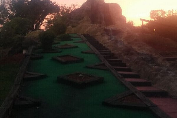 All luck, no skill on this downhill slope with a view of the castle on the mini-golf course at Magic Mountain Family Fun Center.
