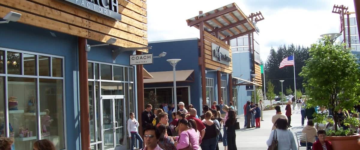 A shopping area with a Coach Factory store and a Coach store.