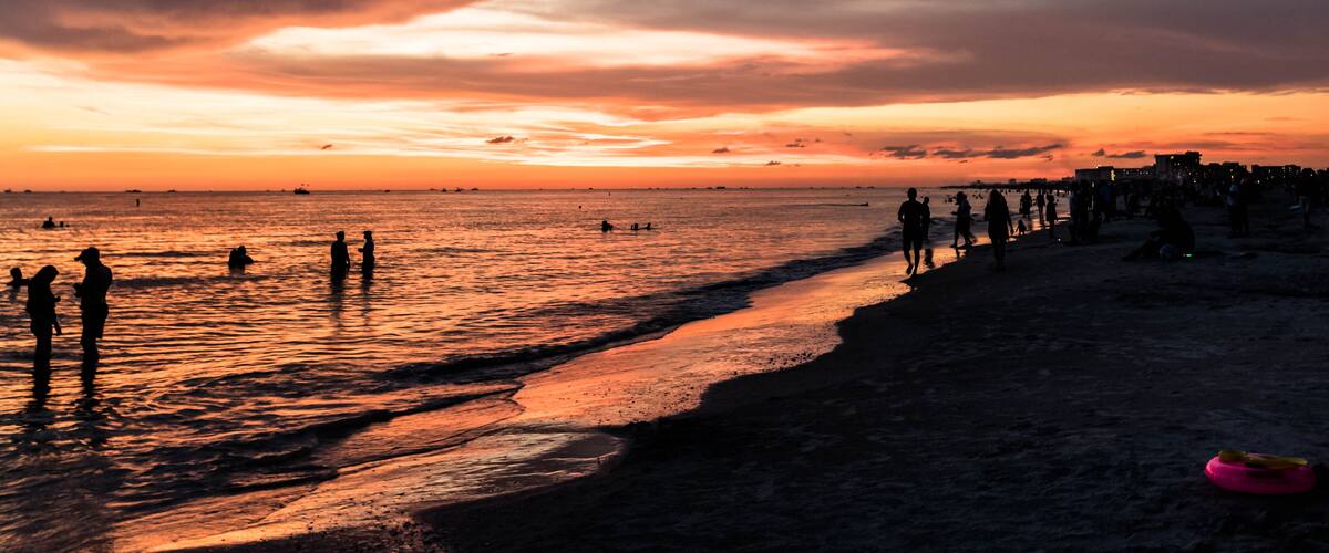 People partying on the beach at sunset in Treasure Island, Florida