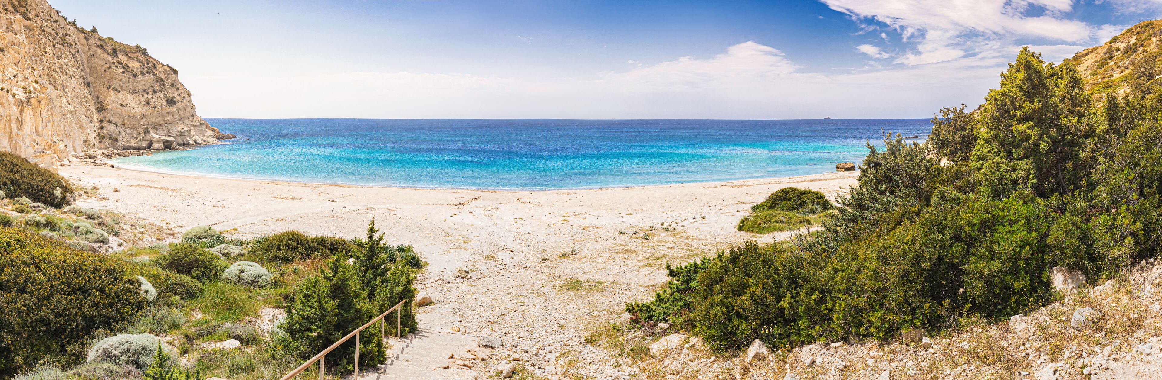 Panoramic view of Cleopatra cove beach with turquoise water and green vegetation in Cesme, Turkey