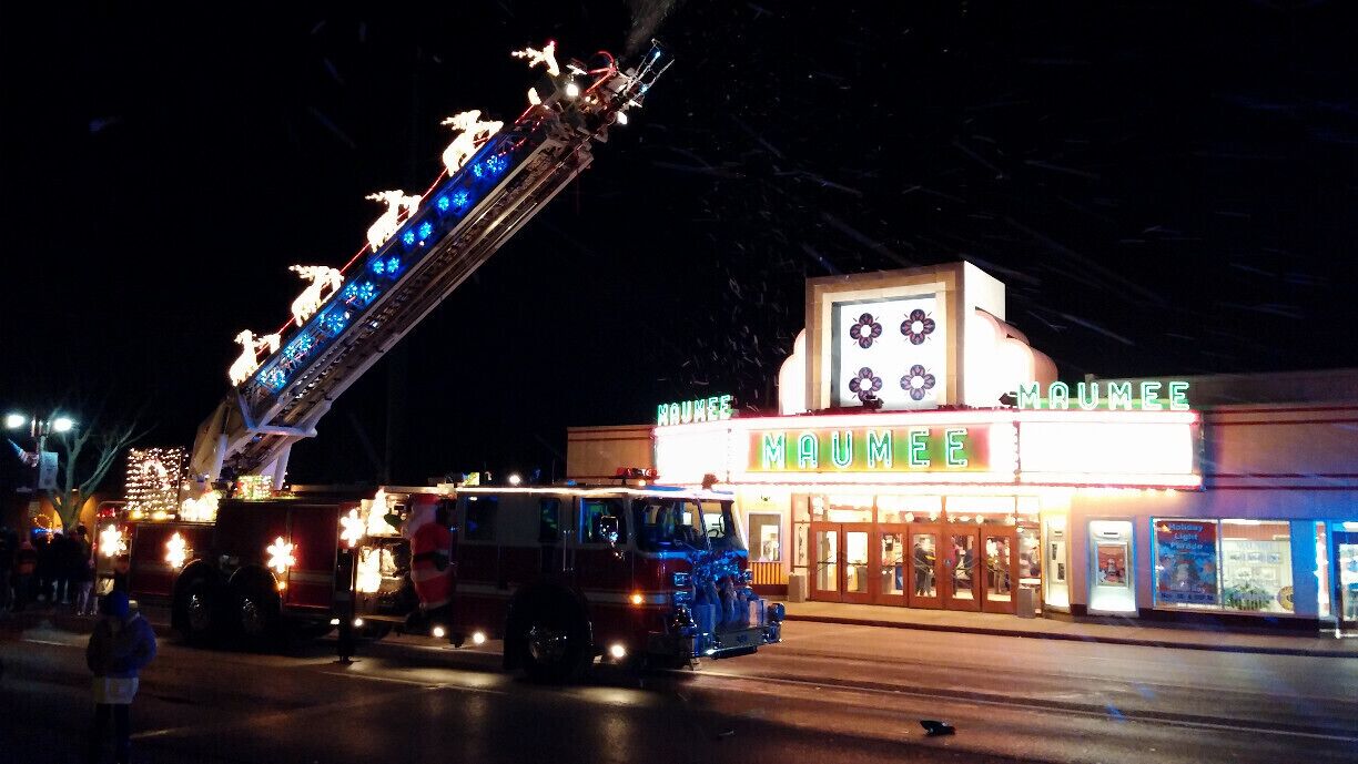 The timeless marquee of the Maumee Indoor Theatre with the City of Maumee Fire Dept's ladder truck all decked out for the holiday parade.