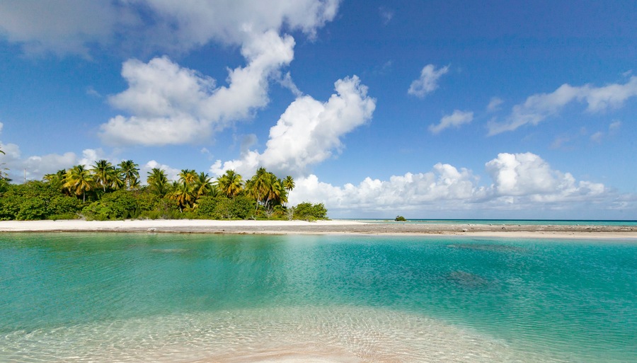 reef ring, lagoon and motu with palm trees on Makemo Atoll, Tuamotus archipelago, French Polynesia, France,