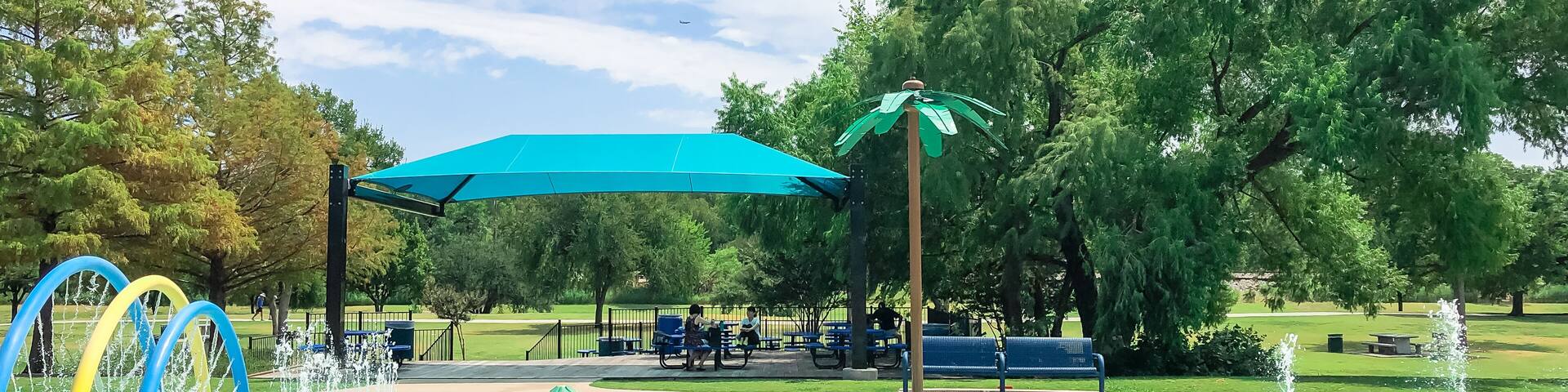 Modern splash park with shaded picnic areas for summertime activities near Dallas, Texas, America