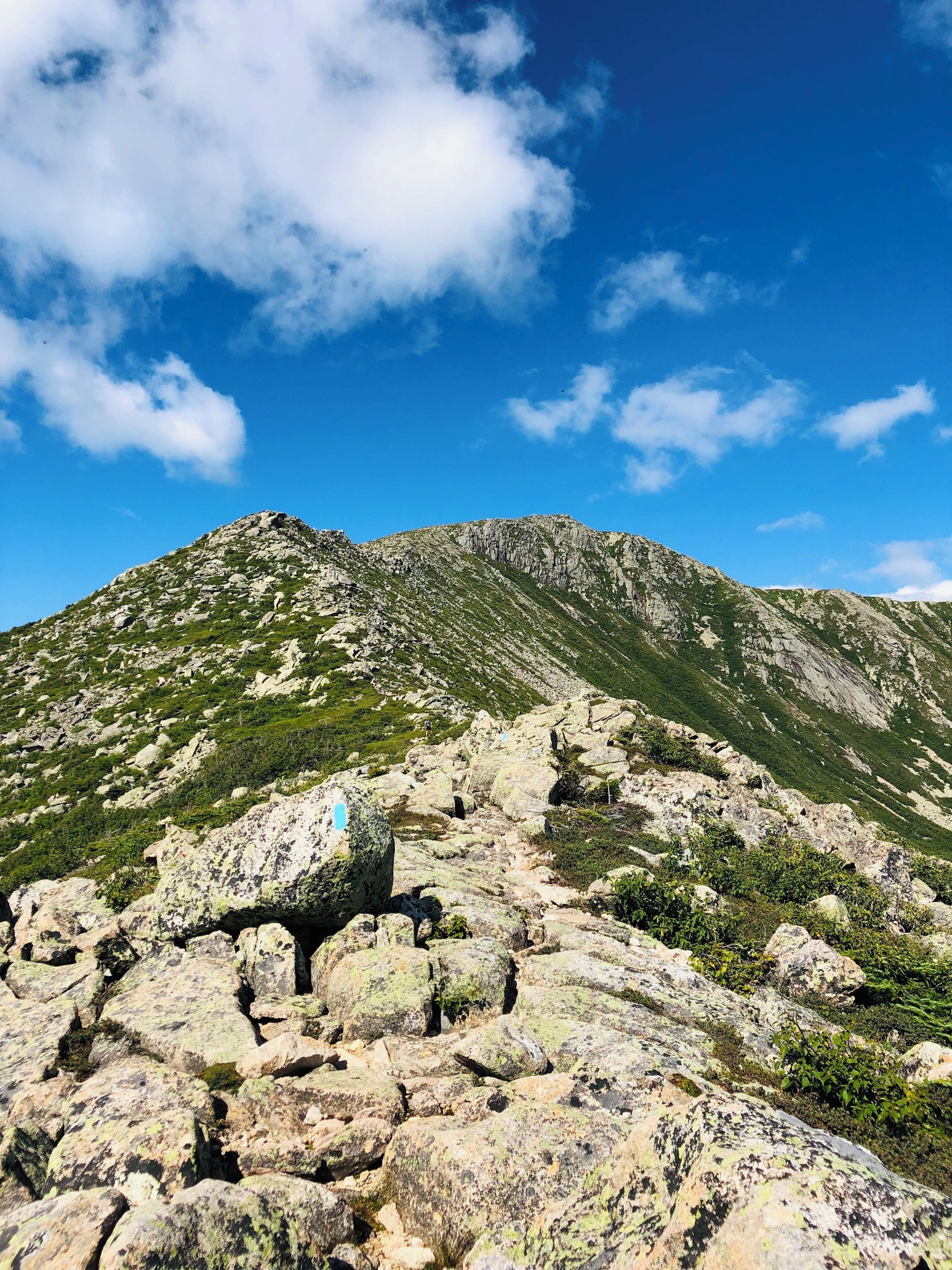 A rocky mountain landscape with a clear blue sky.