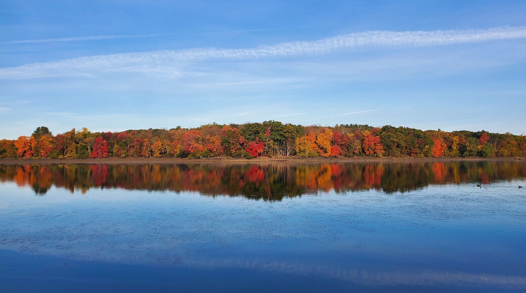 Autumn colors are reflected in the waters of a New England lake