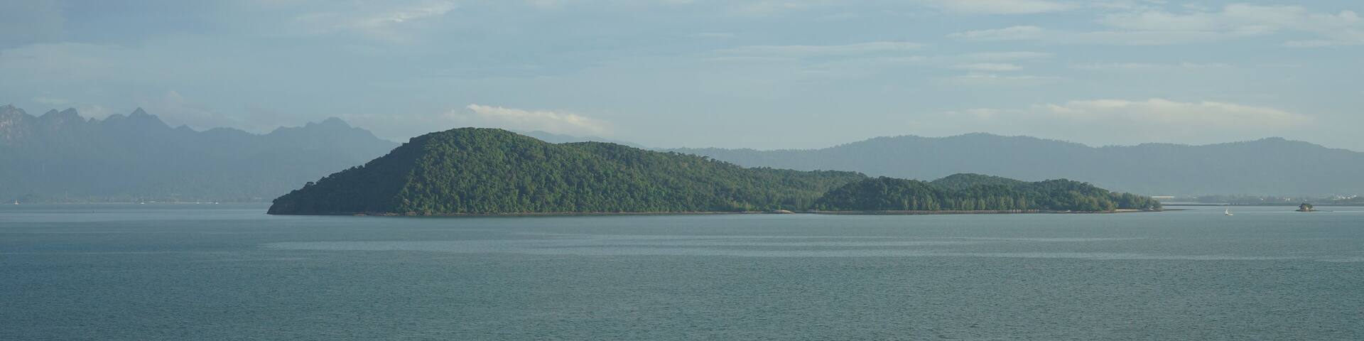 Malaysia, Langkawi, view of the island Pulau Rebak Besar and its lush green coastline of Kedawang as seen from a cruise ship
