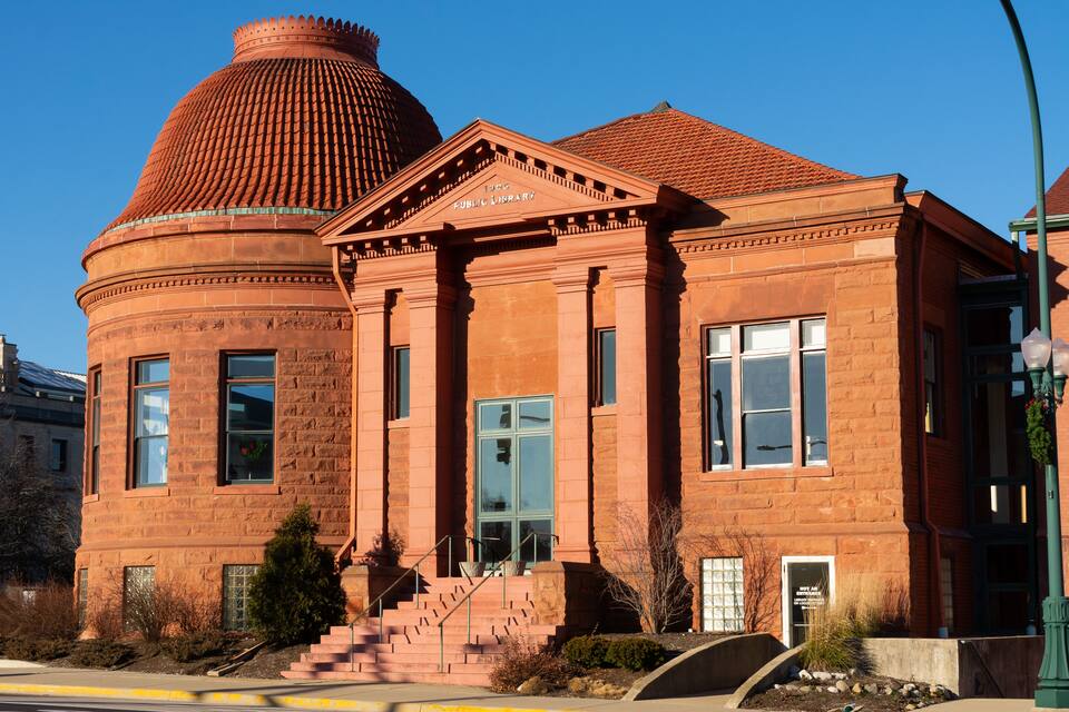 A red brick building with a dome and columns, labeled "Public Library."