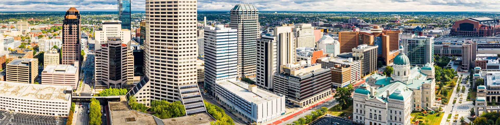 Drone view of the Indiana Statehouse and Indianapolis skyline on a late afternoon. Indianapolis is the state capital and most-populous city of the U.S. state of Indiana and the seat of Marion County.