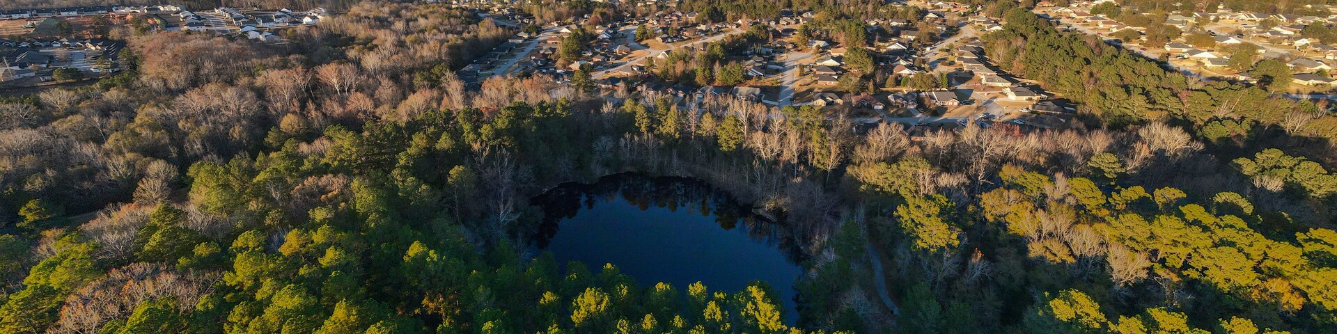 Aerial landscape of pond at Euchee Creek Greenway Trail during Fall in Grovetown Augusta Georgia