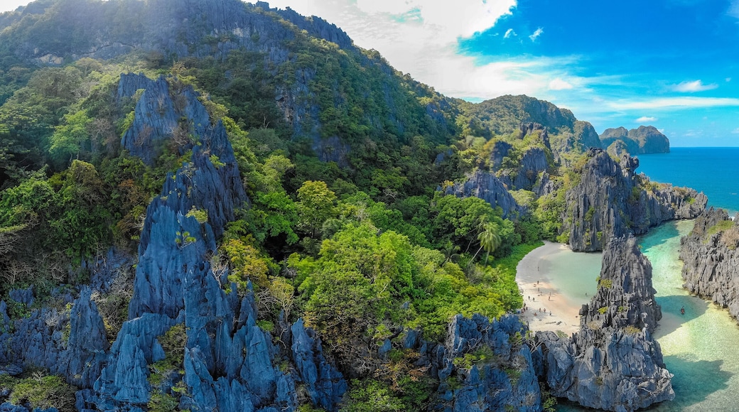 Aerial view of Hidden beach in Matinloc Island, El Nido, Palawan, Philippines - Tour C route - Paradise lagoon and beach in tropical scenery