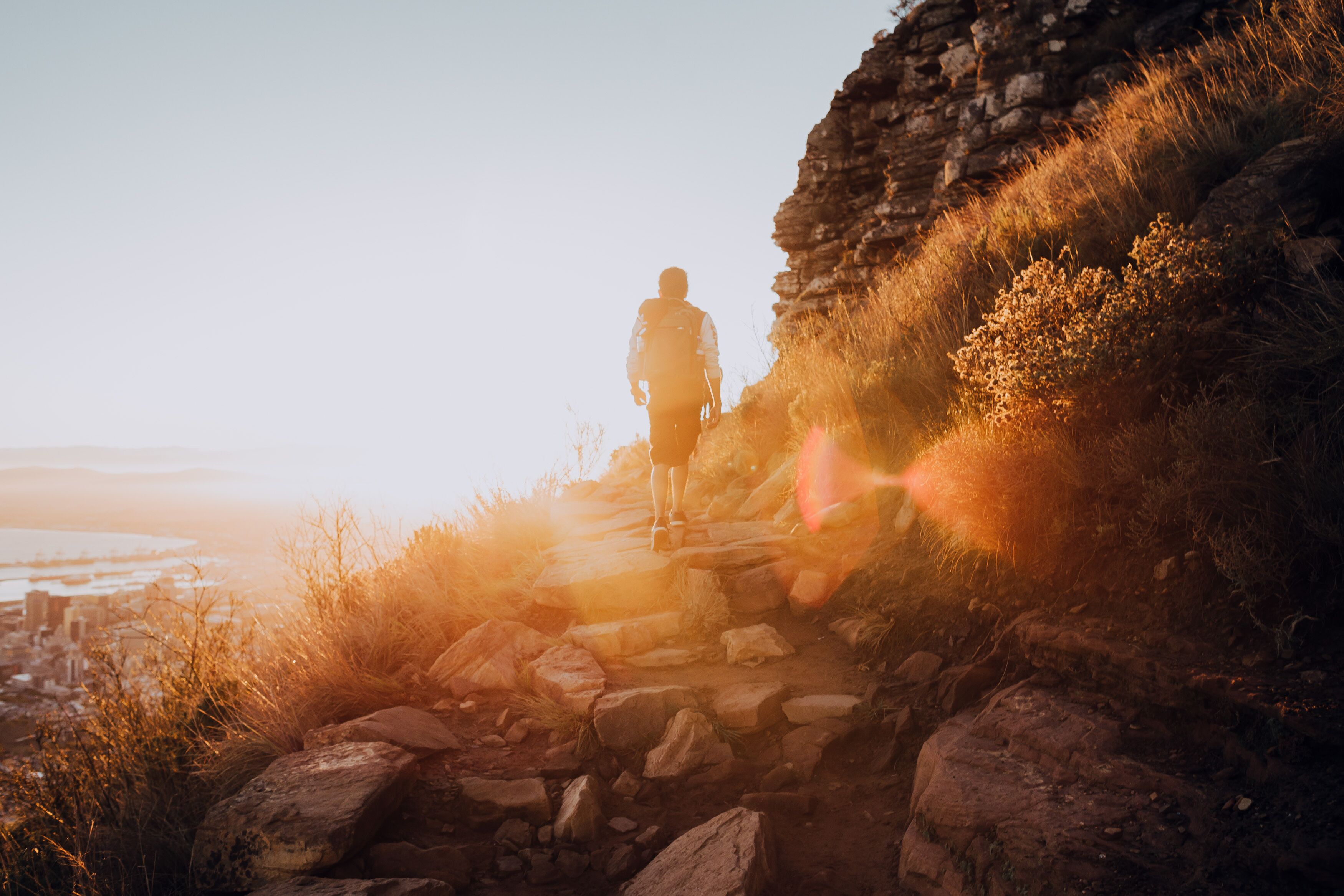 Hiker on mountain at sunrise
