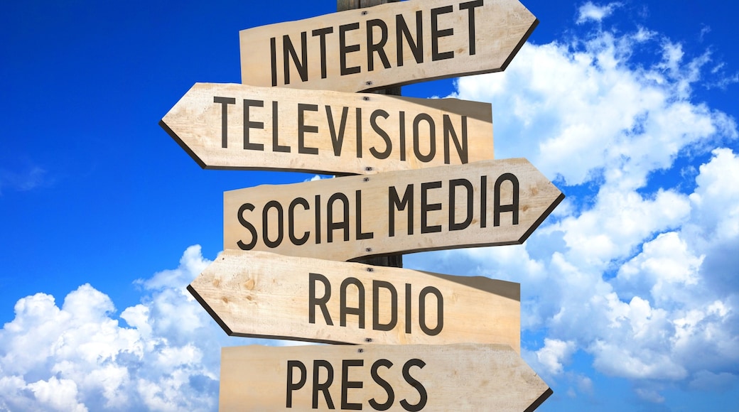 Wooden signpost - media concept (Internet, television, social media, radio, press).