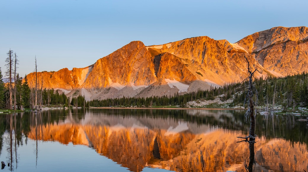 Mirror Lake Reflection - The sunrise lights up the peaks of the Snowy Range Mountains and is reflected in Mirror Lake. Medicine Bow National Forest, Centennial, Wyoming.