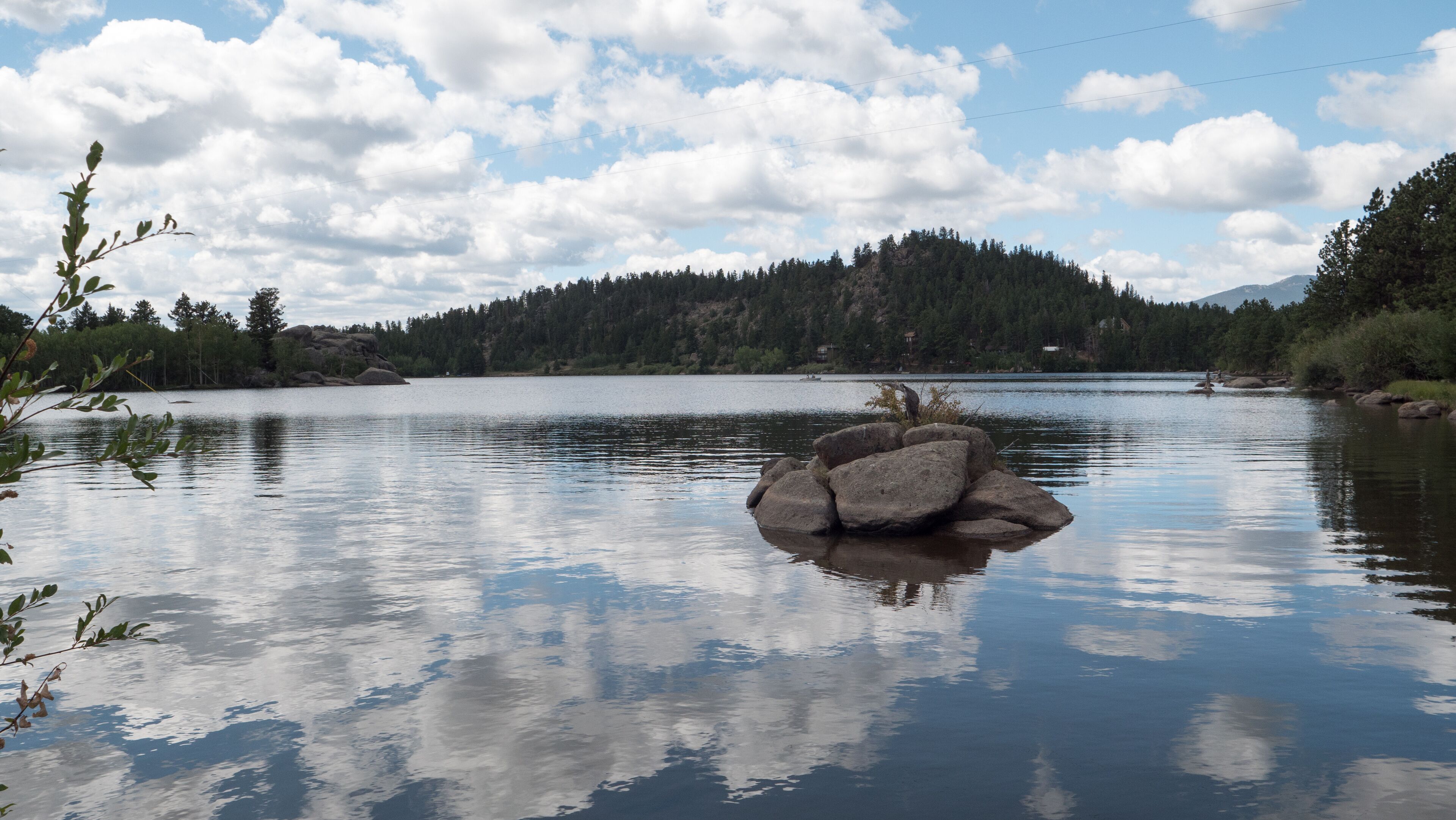Clouds reflecting of the water of the beautiful private Lake Hiawatha in Red Feather Lakes, Colorado.