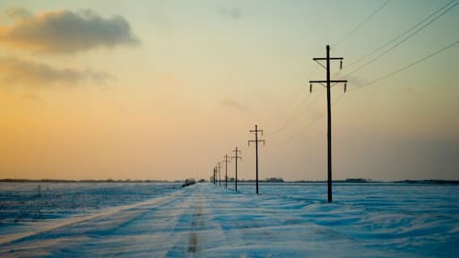 Telephone poles line an empty snow-covered dirt road Mount Pleasant, Iowa on January 4th, 2008.