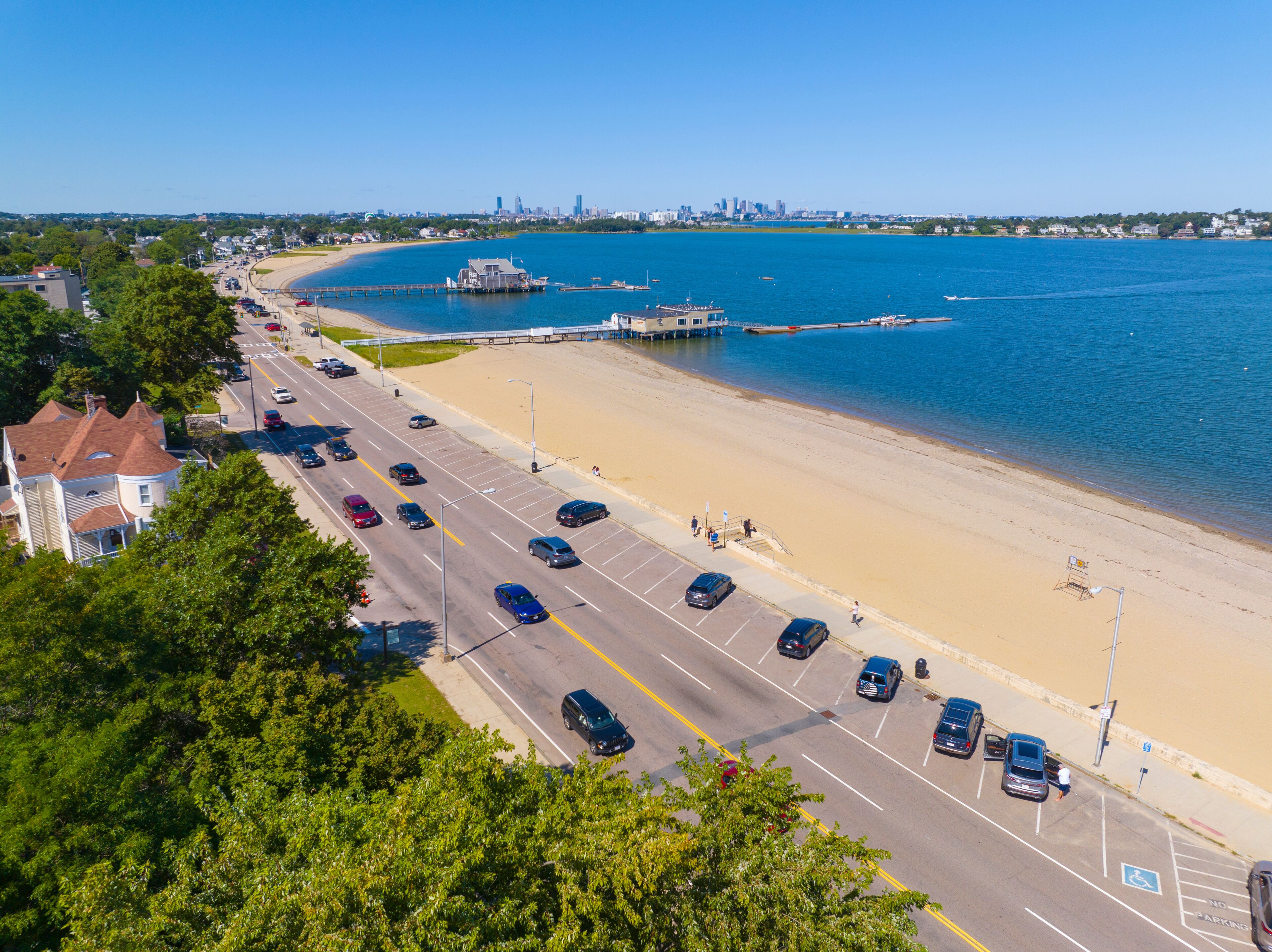 Wollaston Beach aerial view with Squantum and Wollaston Yacht Club with Boston city skyline in Wollaston, city of Quincy, Massachusetts MA, USA.