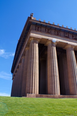 A classical building with large columns and a detailed frieze.
