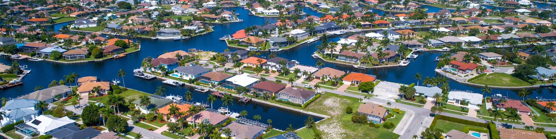 Aerial View Showing the Waterways in Marco Island, Florida with the Gulf of Mexico in the Distance with the Beach and Real Estate