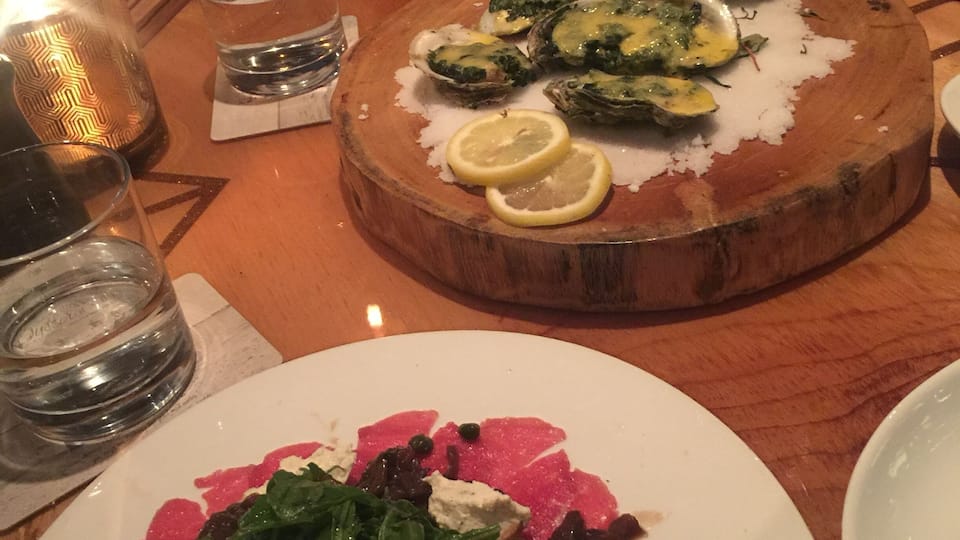 The Oyster Society in Marco Island is a great place to enjoy oysters and fresh cuisine with a glass of red wine.