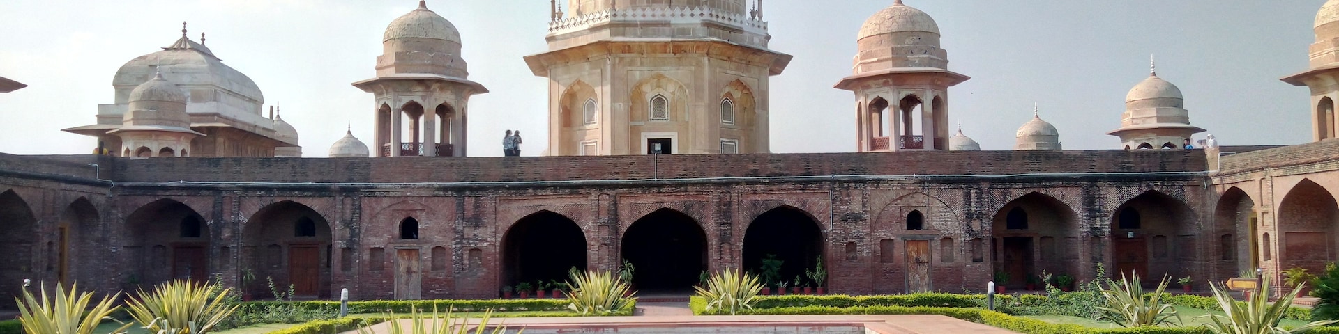 A historic building with domed architecture and arched corridors.
