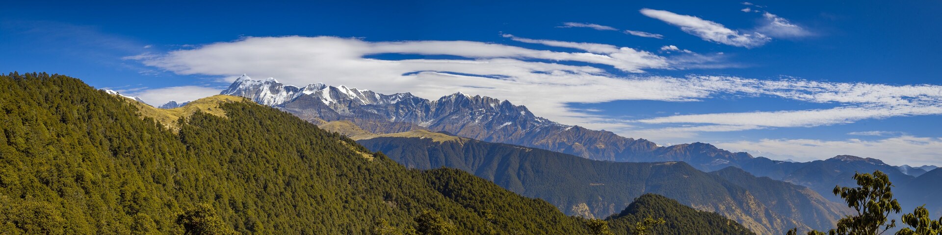 Landscape with snow. Scenic view f Himalayan snow-covered mountain range, on a trek to Bramatal, Uttarakhand, India.