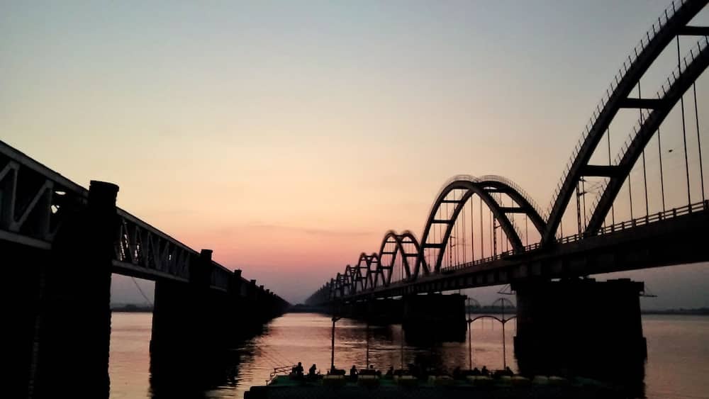 A bridge with a distinctive arch design spanning over a river.
