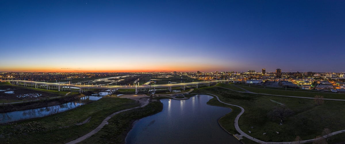Panoramic aerial drone picture of Dallas skyline and Trammel Crow Park at sunset in winter