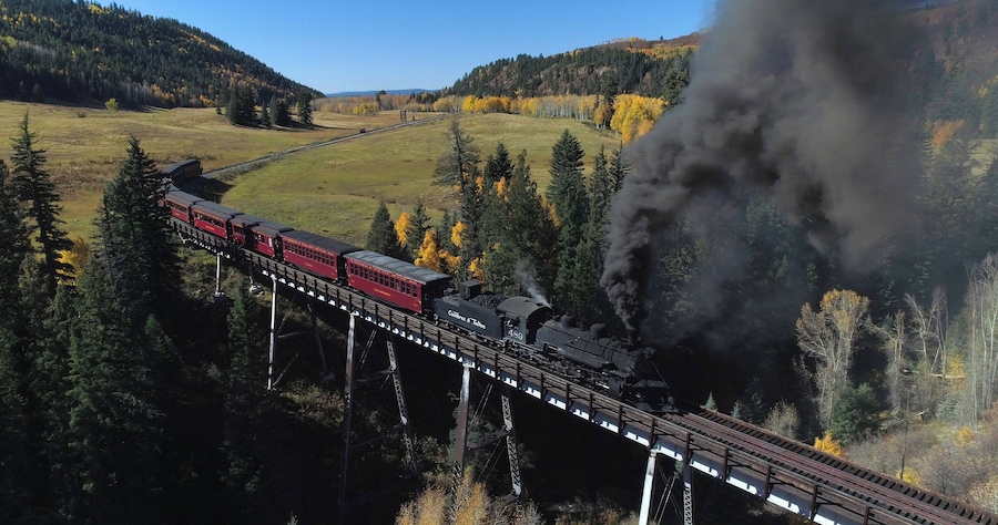 The Cumbres & Toltec is a 3 ft narrow-gauge scenic railroad running for 64 miles between Antonito, Colorado and Chama, New Mexico. Fall scenic tours book fast, plan ahead if you want to catch a ride! #ADVENTURE