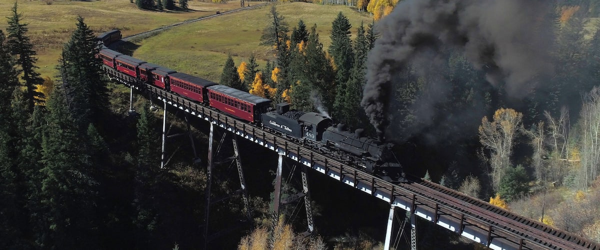 The Cumbres & Toltec is a 3 ft narrow-gauge scenic railroad running for 64 miles between Antonito, Colorado and Chama, New Mexico. Fall scenic tours book fast, plan ahead if you want to catch a ride! #ADVENTURE