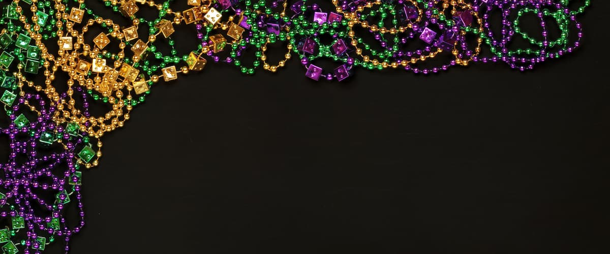 A collection of colorful Mardi Gras beads and beads with purple and gold accents.