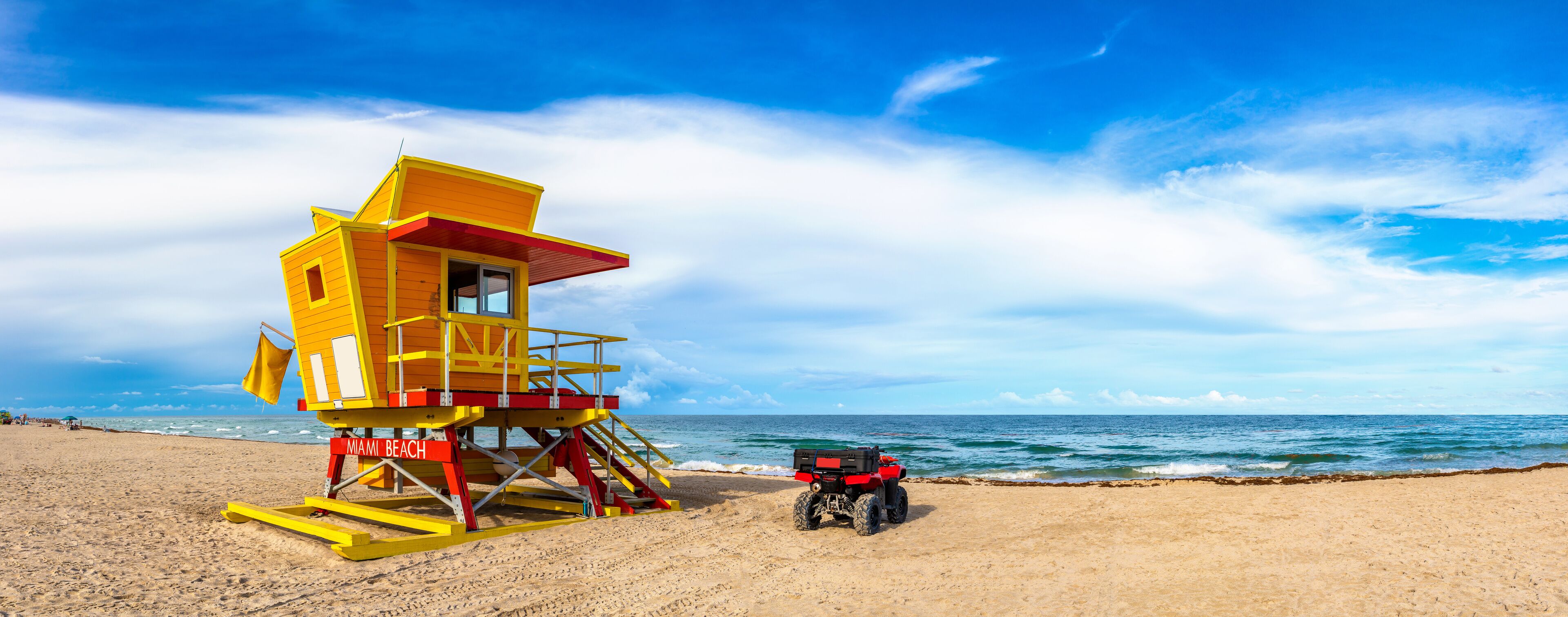 A lifeguard tower on Miami Beach with a red ATV parked nearby.