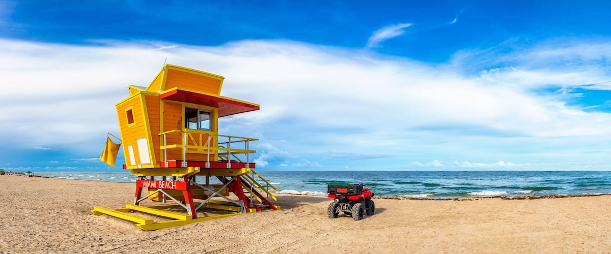 A lifeguard tower on Miami Beach with a red ATV parked nearby.