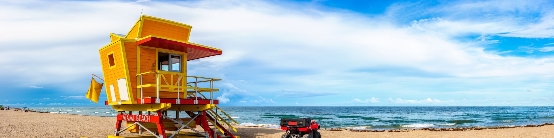 A lifeguard tower on Miami Beach with a red ATV parked nearby.