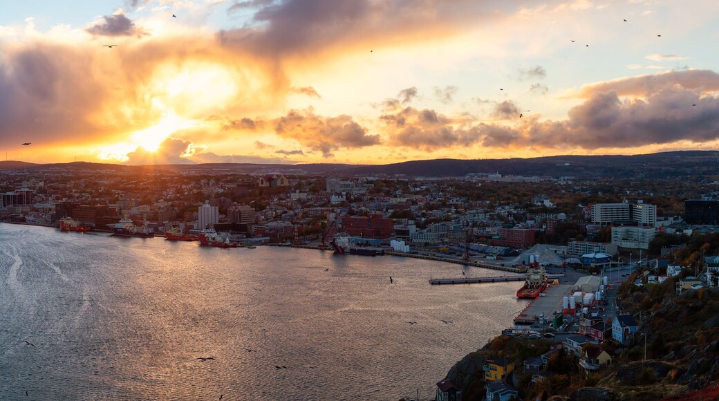 Aerial panoramic view of a modern cityscape on the Atlantic Ocean Coast during a dramatic sunset. Taken in St. John's, Newfoundland and Labrador, Canada.