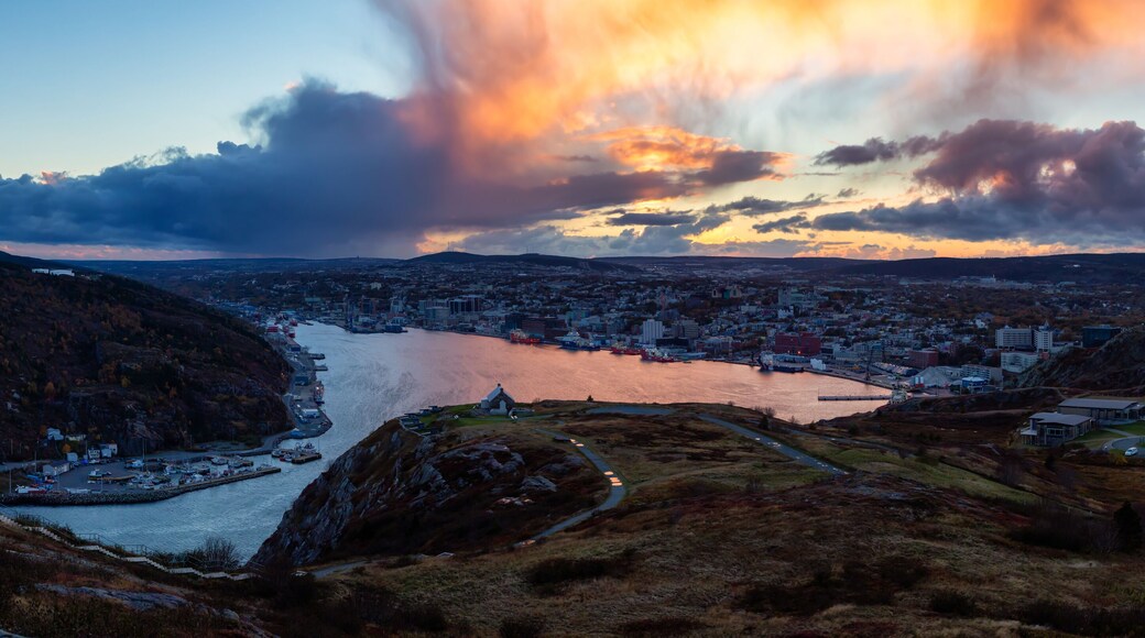 Aerial panoramic view of a modern cityscape on the Atlantic Ocean Coast during a dramatic sunset. Taken in St. John's, Newfoundland and Labrador, Canada.