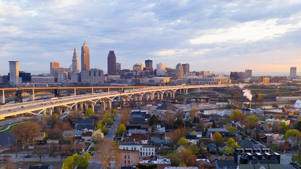 A city skyline with a prominent bridge and industrial area.