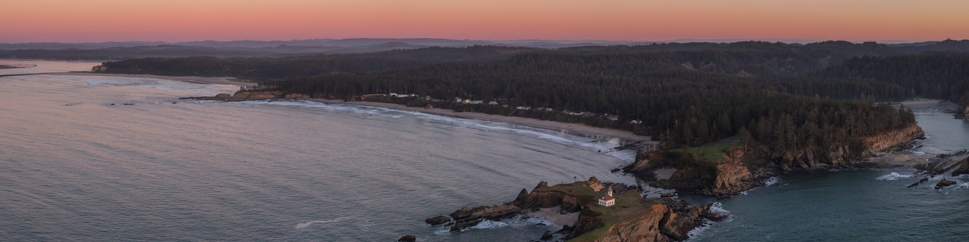 Cape Arago Lighthouse at the Oregon Coast at sunset.