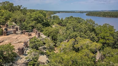 Aerial Drone View of Blue Lake Surrounded by Forest of Green Trees With Rocky Landscape in Lake Mineral Wells State Park in Mineral Wells, Texas