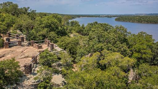 Aerial Drone View of Blue Lake Surrounded by Forest of Green Trees With Rocky Landscape in Lake Mineral Wells State Park in Mineral Wells, Texas
