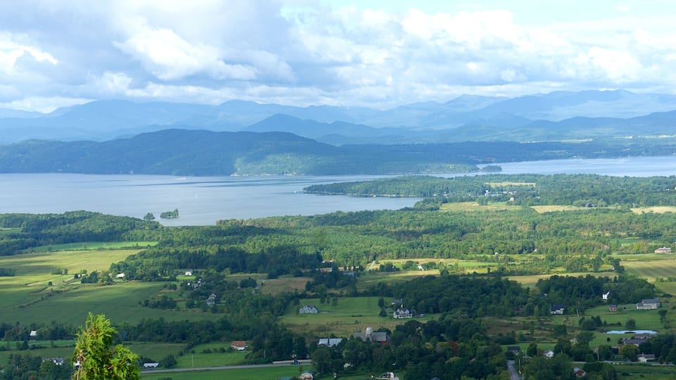 A lake surrounded by mountains and greenery.