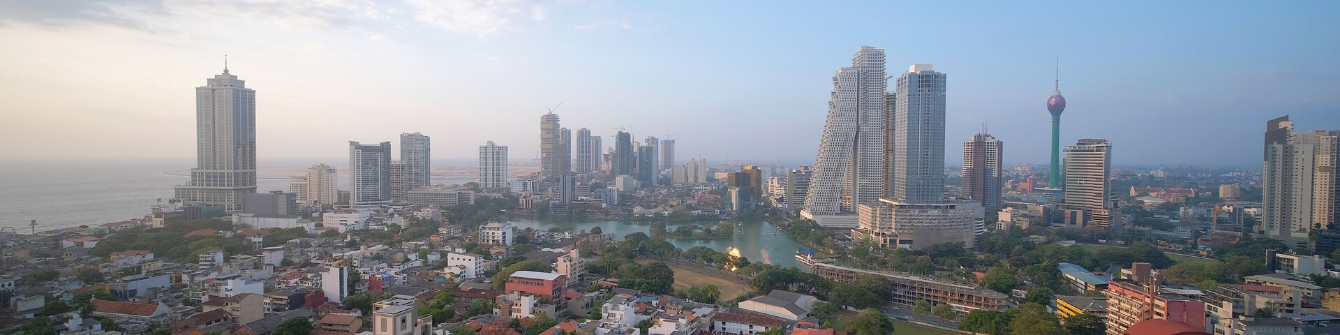 Colombo cityscape with view of Beira Lake surrounded by ny large businesses, condos and Lotus Tower