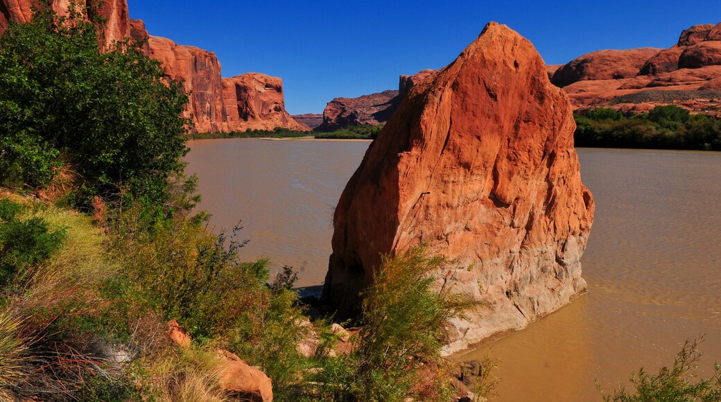 The Colorado river cutting through red rock canyons on the Utah State Route 279, the Lower Colorado River Scenic Byway U-279, or Potash Road, downstream from Moab, Utah, southwest USA.