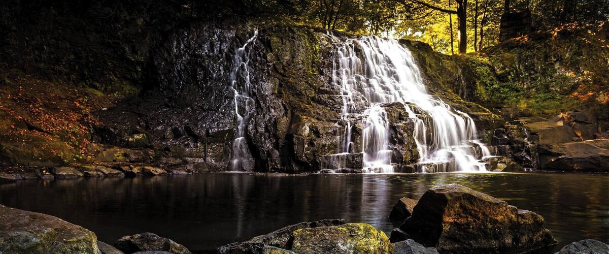 This photo was taken during a nice fall weekend. The water level was low enough to cross to the other side to capture the falls from a different angle than most. Best time however is early morning before most people get there.